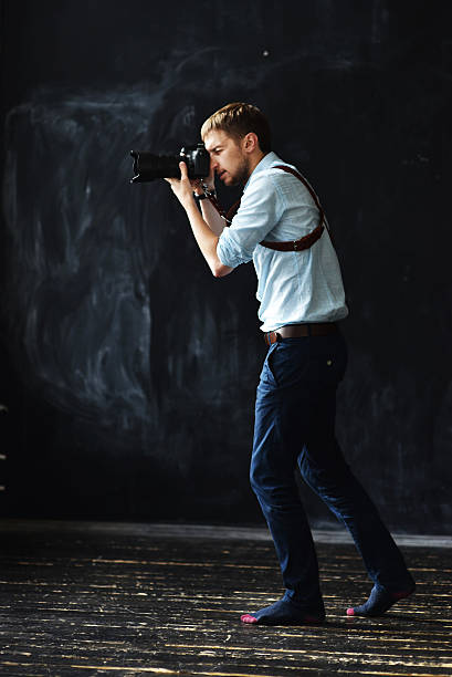 istock photographer working in photostudio with camera in hands 613773000