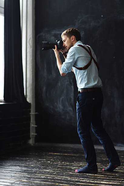 istock photographer working in photostudio with camera in hands 613773022