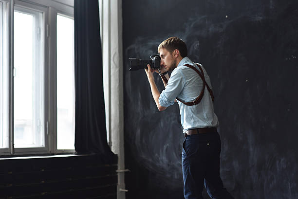 istock photographer working in photostudio with camera in hands 613773048
