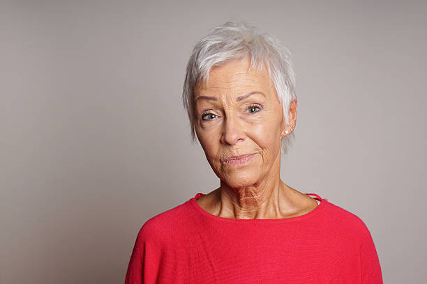 istock mature woman with skeptical look on her face 613773144