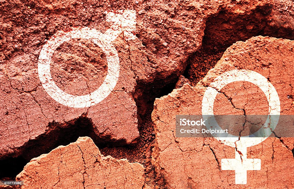 Gender symbols on earth background with a big crack Gender symbols on earth background with a big crack, gender gap concept Human Gender Stock Photo