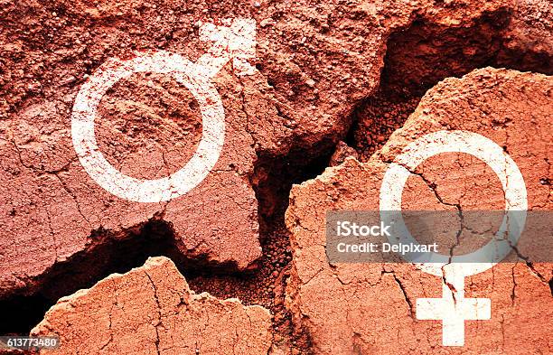Gender Symbols On Earth Background With A Big Crack Stock Photo - Download Image Now