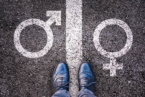 Legs with gender symbol on asphalt, gender concept Legs with gender symbol on asphalt, gender concept bisexuality stock pictures, royalty-free photos & images