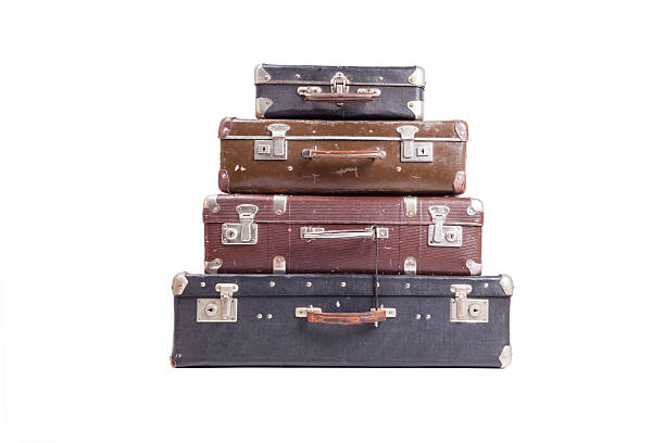 istock Stack of old vintage suitcases isolated on white 613773706