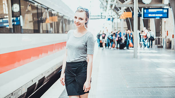 istock Happy young woman standing on a platform 613775396