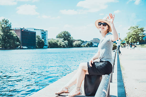 istock Happy friendly woman waving at the camera 613775536