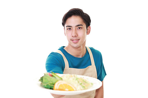 istock Smiling Asian waiter 613775916