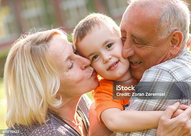 Happy Grandparent With Grandson Embracing Stock Photo - Download Image Now - Grandfather, Grandparent, Child