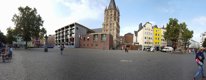 Cologne, Germany - September 23, 2016: Panorama of the Alter Markt (old market) in Cologne, Germany. In the near of the Cologne Cathedral in the historic old town is a place called Alter Markt. People walking in the street, sitting in small restaurants or enjoying the summer sun