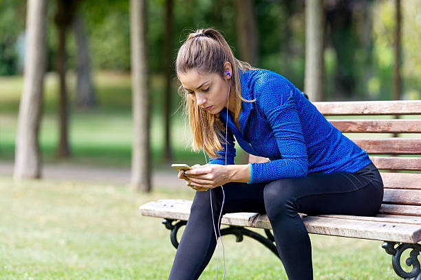 istock Choosing her favorite workout music 613778628
