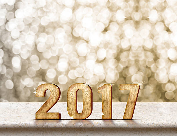istock Happy New Year 2017 wood on marble table with sparkling 613779192