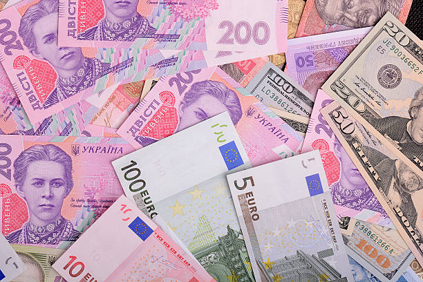 istock One hundred dollar bill on the background of european euro 613779708