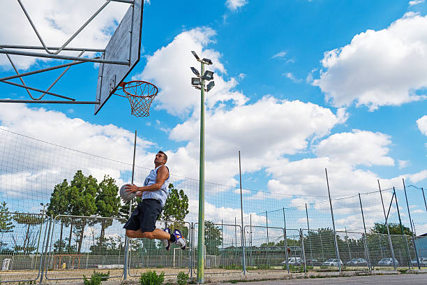 istock basketball player jumping to the hoop 613780236