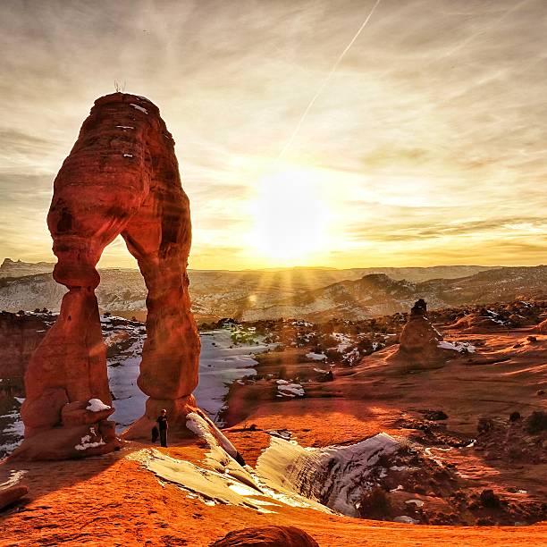 istock Delicate Arch Melting Snow Sunset Star Rays, Arches National Park 613780284