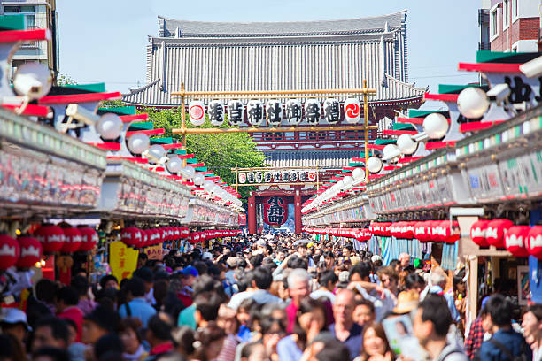 Asakusa TEMPLE Tokyo, Japan - MAY 11, 2014: Crowd of people at Nakamise shopping street, the walkway shopping road to Senso-ji Temple shinto photos stock pictures, royalty-free photos & images