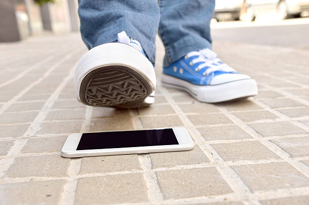 istock stepping the smart phone in the city 613780442