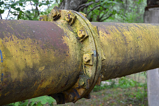 istock Old metal pipe on the bolts . 613780570