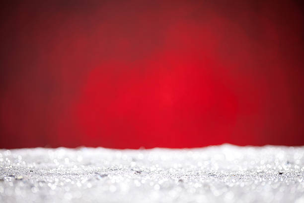 istock Close up of silver glitter with red background 613780934