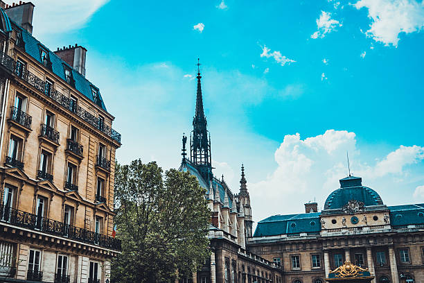 istock Church tower in between historic buildings 613781120