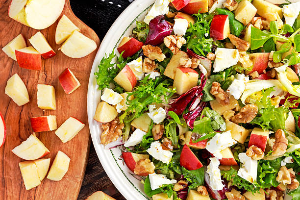 istock Light Fresh Home made fruit apple salad with walnuts, vegetables 613781206