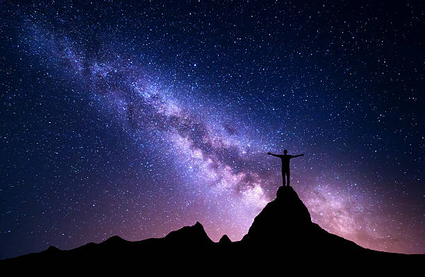 istock Silhouette of a standing man on the mountain peak 613781462