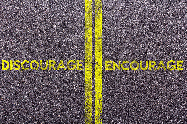 istock Tarmac with the words discourage and encourage 613781490