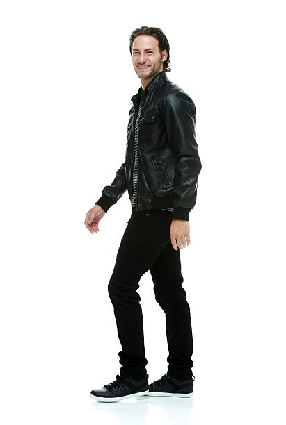 istock Smiling casual man walking 613781524