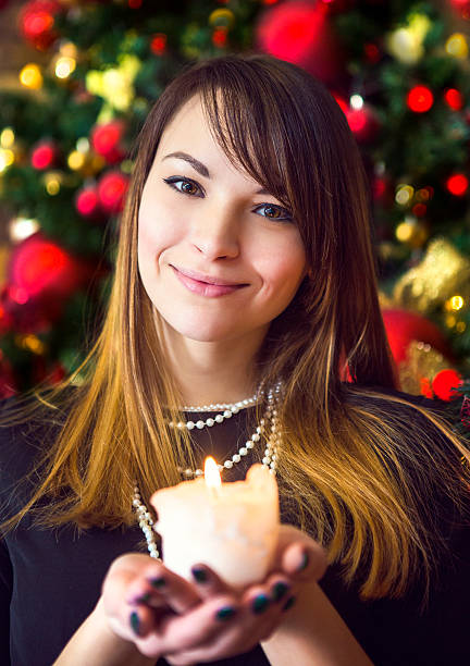 istock Attractive brunette young woman smiling while holding a burning 613782102