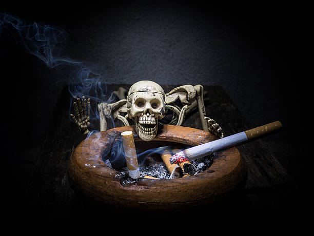 istock Still life skull and cigarette smoke. 613782156