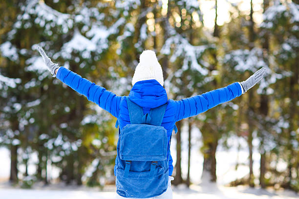 istock Woman hiking in white winter forest 613782222
