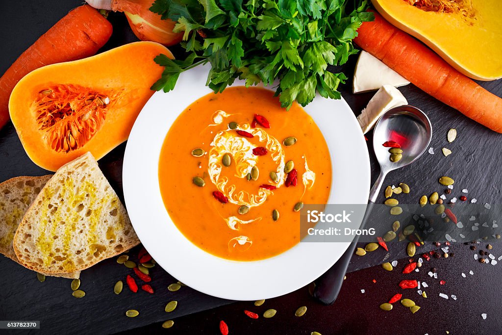 Smooth butternut squash and carrot soup with cream, pumpkin seeds Smooth butternut squash and carrot soup with cream, pumpkin seeds goji berries. Autumn Stock Photo