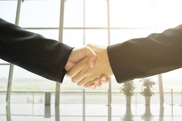istock Business people handshake in office background. 613782582
