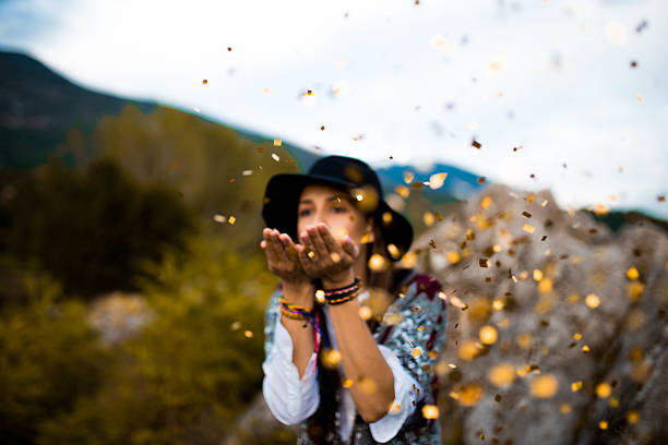 istock Hippie girl blowing confetti 613783540