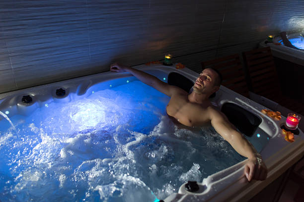 istock Man relaxing in hot tub 613784270