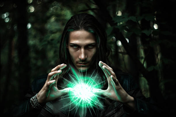 man with a mysterious glowing orb. Long haired white male with a mystical glowing orb to signify power, magic, spirituality and so forth merlin the wizard stock pictures, royalty-free photos & images