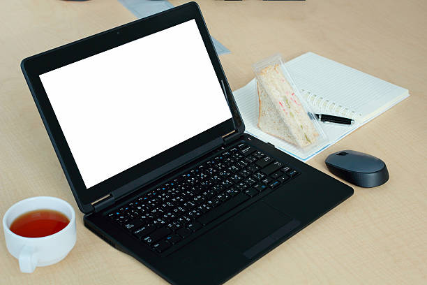 istock Laptop with blank screen on desk in Conference room. 613784890