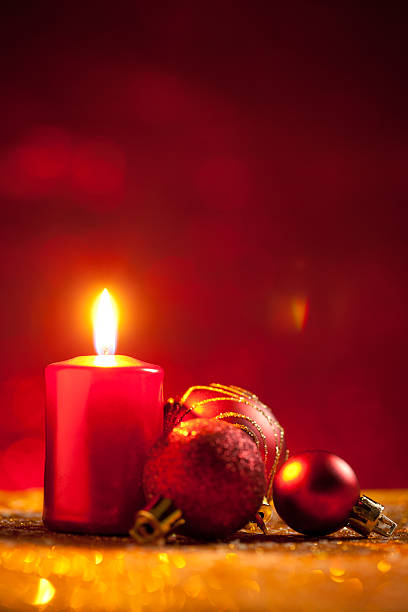 istock Candle and baubles on glitter with red background 613785716