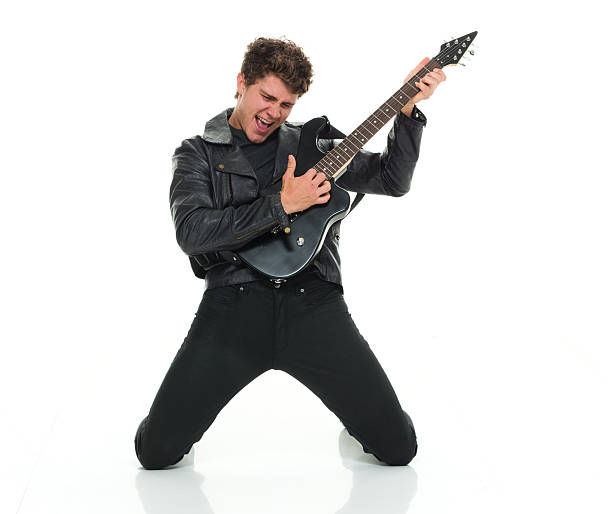 casual hombre tocando la guitarra - isolated on white studio shot guitar young men fotografías e imágenes de stock