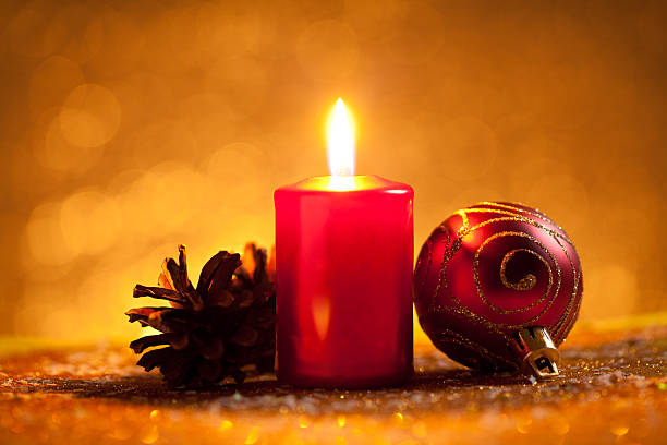 istock Candle and bauble on glitter with gold background 613787256