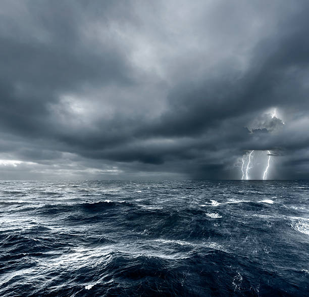 intense thunderstorm over ocean with lightning. - storm cloud storm dramatic sky hurricane imagens e fotografias de stock