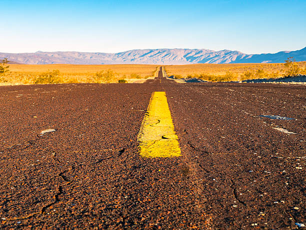istock Deserted Desert Valley Road at Sunrise 613788730