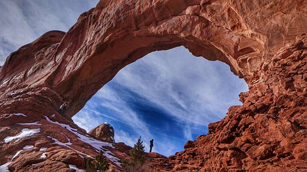 Winter Morning,Snow, Person, Windows Arch, Arches National Park, Utah stock photo
