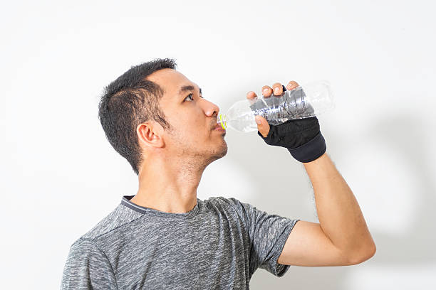 istock Asian man drinking from water bottle 613789570