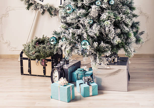 istock Close up decorated fir tree and gift boxes 613790654