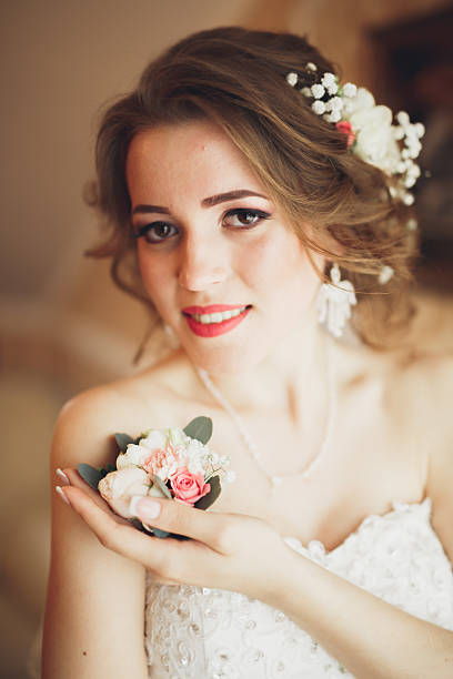 istock Luxury bride in white dress posing while preparing for the 613790764