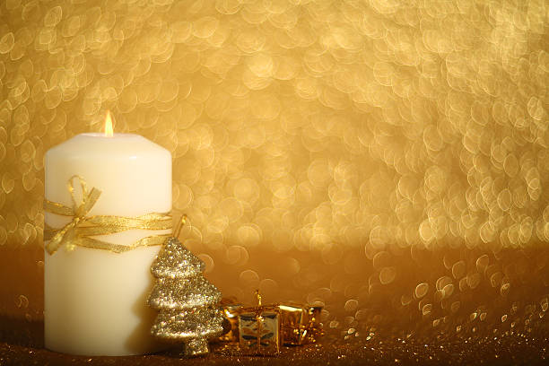 istock Christmas candle on shiny background 613792754