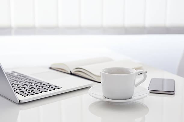 istock Workplace with laptop, phone and coffee cup 613792778