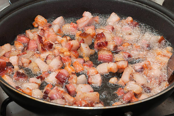 istock Frying bacon pieces in a pan with hot oil. 613793890
