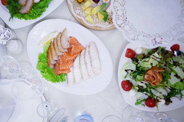 istock Appetizers. Various types of cheese, salami and prosciutto. Decorated table 613793922