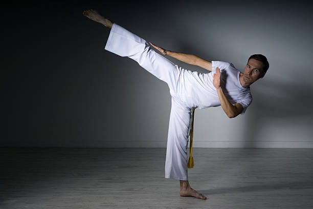 istock Man in sportswear performing a kick. 613794774